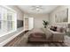 A serene bedroom with warm lighting and an open doorway, creating a cozy and inviting atmosphere at 239 N Faulkner Way, Davidson, NC 28036