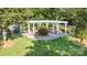 A close aerial shot shows a community park with a white pergola, seating, shrubbery and lawn at 239 N Faulkner Way, Davidson, NC 28036