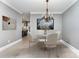 Formal dining room with a chandelier and marble table, ideal for Gathering gatherings and dinner parties at 239 N Faulkner Way, Davidson, NC 28036