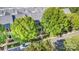 An exterior elevation shows a traditional brick townhouse with dual balconies surrounded by lush trees and landscaping at 239 N Faulkner Way, Davidson, NC 28036