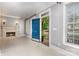 Inviting foyer with a fireplace, built-in shelves, and a view of the front porch through the open blue door at 239 N Faulkner Way, Davidson, NC 28036