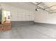 Epoxy floored garage with shelving offers space for parking and storage at 239 N Faulkner Way, Davidson, NC 28036