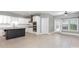 Open kitchen with white cabinets, stainless steel appliances, a black island, and a door to the backyard at 239 N Faulkner Way, Davidson, NC 28036