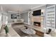 Stylish living room boasting a fireplace, custom built-ins, and elegant dining area for entertaining guests at 239 N Faulkner Way, Davidson, NC 28036