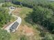 Expansive property showcasing lush greenery, a long driveway, and peaceful surroundings at 2676 Will Schronce Rd, Iron Station, NC 28080