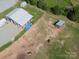 Aerial view of a sprawling farm with outbuildings, pastures, and serene country setting at 2676 Will Schronce Rd, Iron Station, NC 28080