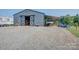 Large metal barn with open sliding doors and covered parking featuring ample gravel space at 2676 Will Schronce Rd, Iron Station, NC 28080