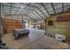 Wide view of the barn interior showing stalls, equipment and storage space at 2676 Will Schronce Rd, Iron Station, NC 28080