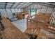 Open barn interior with wooden stalls and ladder access to the attic at 2676 Will Schronce Rd, Iron Station, NC 28080