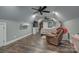Upper level bedroom with wood floors, TV, chair, and closet space, perfect for relaxation and comfort at 2676 Will Schronce Rd, Iron Station, NC 28080
