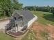 Striking exterior elevation with a second-story deck, professional landscaping, and private driveway at 2676 Will Schronce Rd, Iron Station, NC 28080
