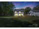Backyard twilight view, highlighting its outdoor space and lighting, enhancing its serene appeal at 2902 Oakdale Rd, Charlotte, NC 28216