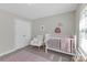 This bedroom features a crib, rocking chair, and a rug at 2902 Oakdale Rd, Charlotte, NC 28216