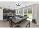 Charming dining area featuring a large table with access to a backyard at 2902 Oakdale Rd, Charlotte, NC 28216