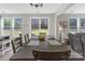 Bright dining area featuring a spacious table, access to a backyard, and cozy seating at 2902 Oakdale Rd, Charlotte, NC 28216