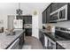 Well-equipped kitchen featuring black cabinets, granite countertops, and stainless steel appliances at 2902 Oakdale Rd, Charlotte, NC 28216
