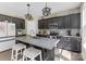 Beautiful kitchen island with black cabinets, granite countertops, and stainless steel appliances at 2902 Oakdale Rd, Charlotte, NC 28216