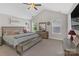 Spacious main bedroom featuring a bench at the foot of the bed and natural light from the windows at 2902 Oakdale Rd, Charlotte, NC 28216
