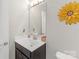 Charming powder room with decorative sunflower mirror, providing a bright and stylish space at 2902 Oakdale Rd, Charlotte, NC 28216