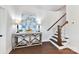 Bright foyer showcases wood floors, elegant console table with artwork, and a staircase leading to the upper level at 330 Armour St # 46, Davidson, NC 28036