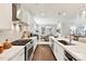 Well-lit kitchen has stainless steel appliances, white cabinets, subway tile backsplash, and an island with seating at 330 Armour St # 46, Davidson, NC 28036