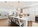 Modern kitchen with stainless steel appliances, white cabinets, and a center island with seating overlooks the living area at 330 Armour St # 46, Davidson, NC 28036
