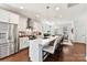 Bright kitchen with stainless steel appliances, center island seating, and pristine white cabinets at 330 Armour St # 46, Davidson, NC 28036