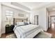 This bedroom features tray ceilings, two bedside tables with lamps, and an ensuite bathroom at 330 Armour St # 46, Davidson, NC 28036