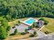 Aerial view of the community pool, clubhouse, parking lot, and surrounding woods at 348 Ox Bow Cir, Mount Holly, NC 28120