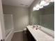 Neutral bathroom featuring a large mirror and tub-shower combination at 348 Ox Bow Cir, Mount Holly, NC 28120