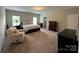 Expansive bedroom suite features a bed, sitting area, and ample natural light at 348 Ox Bow Cir, Mount Holly, NC 28120