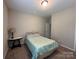 This bedroom features a bed, carpet, bedside table and lamp, and natural lighting at 348 Ox Bow Cir, Mount Holly, NC 28120
