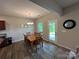 Cozy dining area with hardwood floors, a chandelier, and a view of the backyard at 348 Ox Bow Cir, Mount Holly, NC 28120