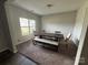 Bright dining room with a large window, carpet flooring and a long dark wood table with bench seating at 348 Ox Bow Cir, Mount Holly, NC 28120