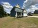Charming two-story home with a well-manicured lawn, landscaping, and paved driveway at 348 Ox Bow Cir, Mount Holly, NC 28120