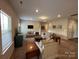 Spacious living room with plush seating, a media center, and an open layout to the kitchen at 348 Ox Bow Cir, Mount Holly, NC 28120