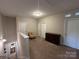 Bright, spacious loft with neutral carpet, three doors, a chair, and a dark wood dresser at 348 Ox Bow Cir, Mount Holly, NC 28120