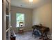 Well-lit home office featuring a desk, chair, and natural light from a large window at 348 Ox Bow Cir, Mount Holly, NC 28120