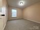 Bedroom provides neutral walls, carpet, and window for natural light at 3660 9Th Street Ne Dr, Hickory, NC 28601