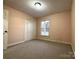 Bedroom offers neutral walls, carpet, and window for natural light at 3660 9Th Street Ne Dr, Hickory, NC 28601