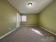 Bedroom with green walls, carpet, and a window at 3660 9Th Street Ne Dr, Hickory, NC 28601