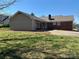 Backyard with grass leads to attached carport on the back of a brick home at 3660 9Th Street Ne Dr, Hickory, NC 28601