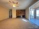 Spacious living room featuring a brick fireplace and view into bright sunroom at 3660 9Th Street Ne Dr, Hickory, NC 28601