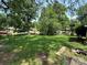 Lush backyard featuring a well-maintained lawn surrounded by mature trees offering ample shade and privacy at 3720 Blandwood Dr, Charlotte, NC 28217