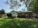 A view of the backyard, featuring a well-maintained lawn, a door, and the home's exterior at 3720 Blandwood Dr, Charlotte, NC 28217
