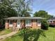 Charming brick home with red shutters, a well-manicured lawn, and a inviting front entrance at 3720 Blandwood Dr, Charlotte, NC 28217