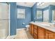 Well-lit bathroom with a shower, tiled floor, window, and spacious vanity at 3915 Planters Watch Dr, Charlotte, NC 28278