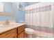Bathroom featuring oak vanity and neutral shower curtain at 3915 Planters Watch Dr, Charlotte, NC 28278