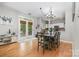 Bright dining area with hardwood floors, French doors, and a modern chandelier at 3915 Planters Watch Dr, Charlotte, NC 28278