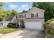 Charming two-story home with a well-manicured lawn, attached two car garage, and vibrant red shutters at 3915 Planters Watch Dr, Charlotte, NC 28278